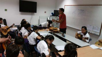 Students learning guitar